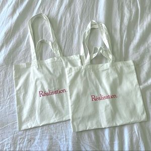 Two brand new realisation par tote bags